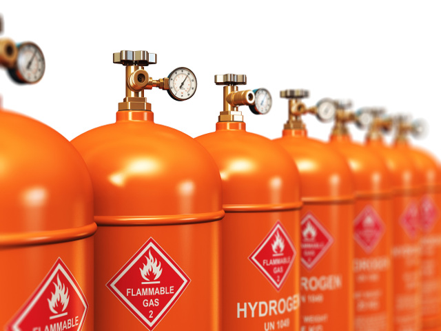 Creative abstract fuel industry manufacturing business concept: 3D render illustration of the group of orange metal steel liquefied compressed natural hydrogen gas containers or cylinders with high pressure gauge meters and valves arranged in row and isolated on white background with selective focus effect